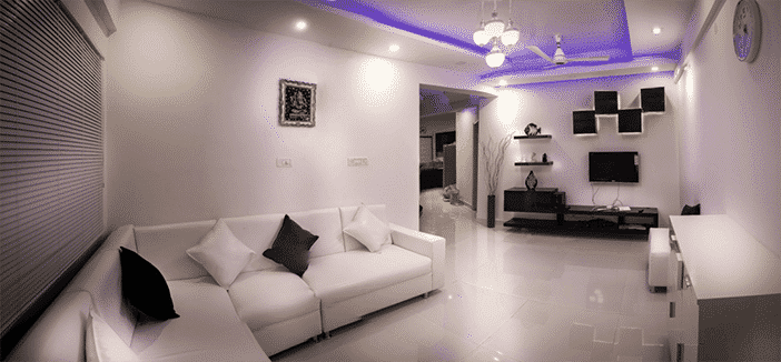 a white room and white couch with purple ceiling lights