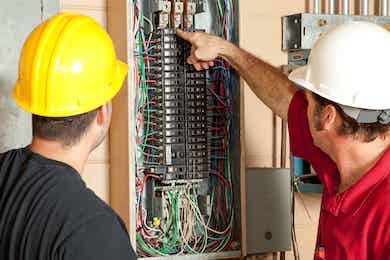 two men checking a service panel upgrade in Boca Raton